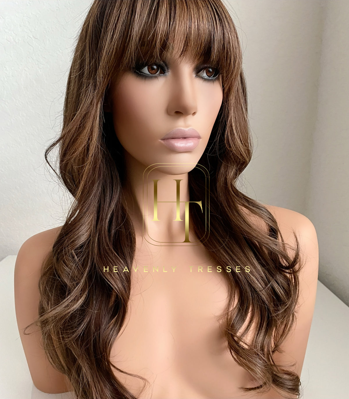Mannequin head with long brown balayage human hair wig on a neutral background, branded 'Heavenly Tresses'.